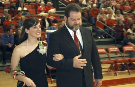 Senior Lindsey Abell, music major, is escorted onto the court by her father just before being crowned Homecoming queen. - Photo by Matthew Diggs