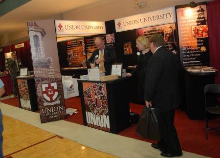 Mark Kahler, assistant VP for university communications, and Kimberly Thornbury, dean of students, man the booth at the Tennessee Baptist Convention at Bellevue Baptist Church. - Photo by Morris Abernathy