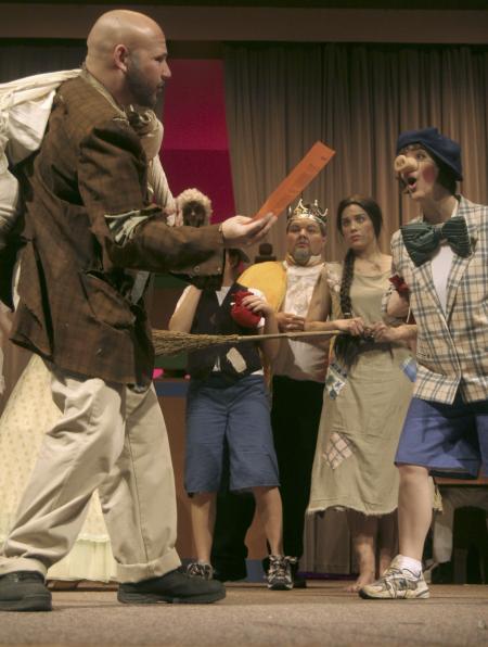 Ben Lancaster as Jack Sprat sells Ashley Diehm the materials to build her house of bricks in the production of <em>The Trial of the Big Bad Wolf</em>. - Photo by Kyle Kurlick