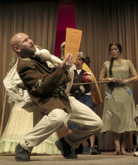Ben Lancaster as Jack Sprat struggles to sell the materials to build a house of bricks as Natalie Newberry and Kali Wagner observe in the production of <em>The Trial of the Big Bad Wolf</em>. - Photo by Kyle Kurlick