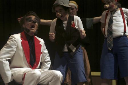 The wolf (Andy Morris) gets his tail burned by the pigs Marcellus (Kali Wagner) and Amadeus (Emily Watlington) while Jack of Jack and Jill fame (Kip Arrowood) portrays a brick wall in <em>The Trial of the Big Bad Wolf</em>. - Photo by Kyle Kurlick