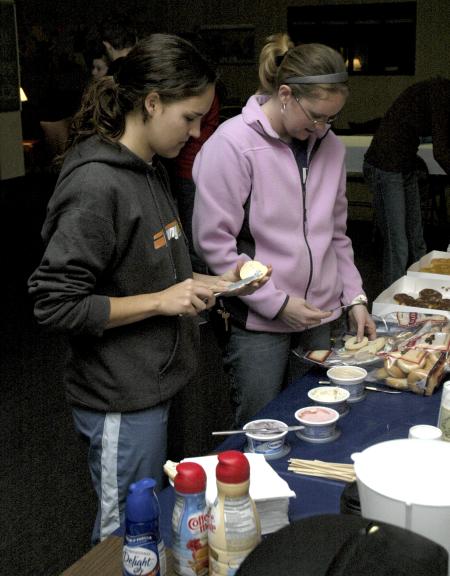 Junior Caitie Maylott, youth ministry major, and Senior Dana Thompson, psychology major, come out for some bagels at the Ode to Bubba's Bagels party in the student lounge. - Photo by Matthew Diggs