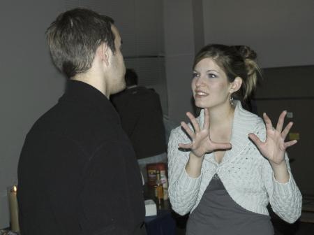 Senior Elisabeth Berry, social work major, and Senior Landon Preston, management major, chat during the senior class' Ode to Bubba's Bagels party in the student lounge. - Photo by Matthew Diggs