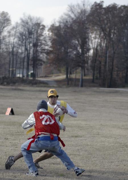 Sophomore Kyle Devore makes a move with the frozen turkey during the annual sophomore class Turkey Bowl. - Photo by Holly Gushee