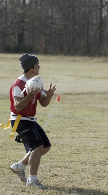 Sophomore Josh Abbotoy looks to make a pass with the frozen turkey during the annual Turkey Bowl. - Photo by Holly Gushee