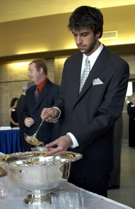 Sophomore Kieler Henry, DMS major, enjoys some punch just before the Tenth Annual Scholarship Banquet. - Photo by Matthew Diggs