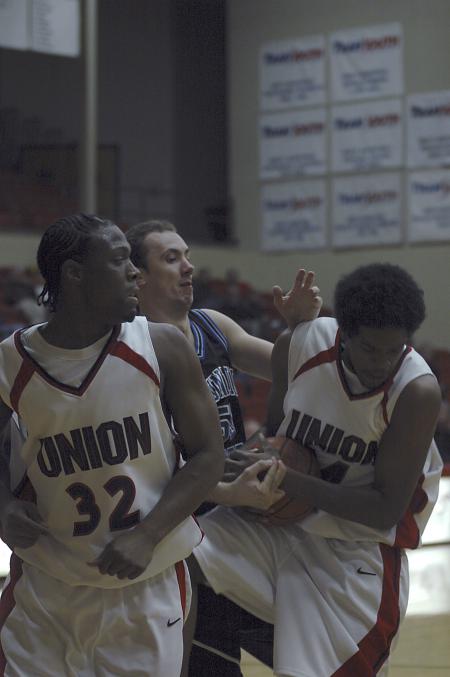 Seniors Mack Bealim and Deywayne Lee struggle for the ball with a Mountain State University player. - Photo by Holly Gushee