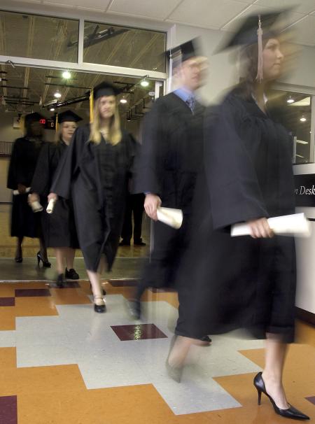 Fall graduates leave the gym at West Jackson to line up for the beginning of their graduation ceremony. - Photo by Kyle Kurlick