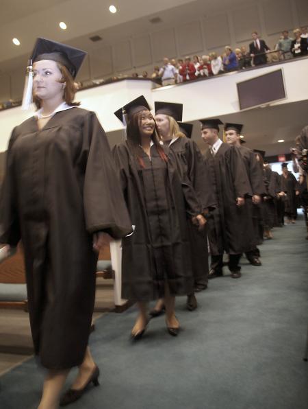 Michelle Lawrence, English graduate, and Nang Mitsamphanh, public relations/advertising graduate, enter the worship center at West Jackson for Union's fall graduation. - Photo by Kyle Kurlick