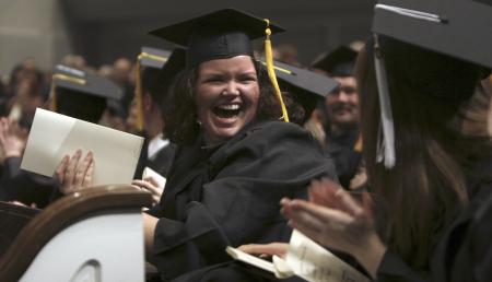 Danielle Pope, mathematics graduate, celebrates with fellow graduates when the class is presented as new alumni. - Photo by Kyle Kurlick