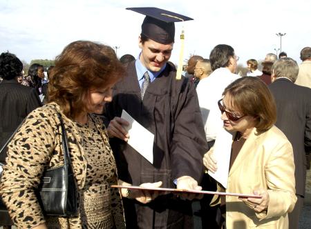 Joel Brunson, nursing graduate, shows off his diploma after fall graduation.  - Photo by Matthew Diggs