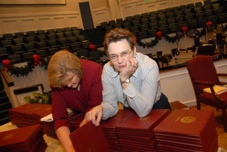 Anita Todd, assistant registrar, and Jane Betts, registrar, work to get each of the diplomas ready for distribution at fall graduation. - Photo by Morris Abernathy