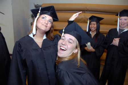 Michelle Lawrence, English graduate, and Heather Phillips, art graduate, ham it up before the fall graduation ceremony. - Photo by Morris Abernathy