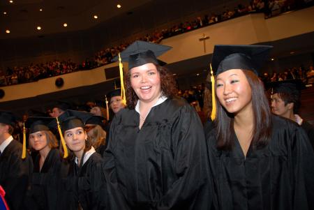 Danielle Pope, mathematics graduate, and Eunice Sung, biology/chemistry graduate, take their places at the beginning of the fall graduation ceremony. - Photo by Morris Abernathy