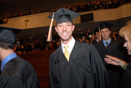 Joel Polk, management graduate, enters his row at the beginning of fall graduation. - Photo by Morris Abernathy