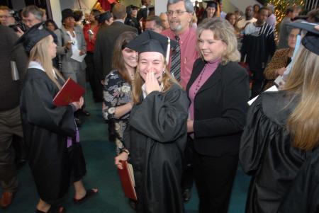 Art graduate Heather Phillips giggles with her family after the fall graduation ceremony. - Photo by Morris Abernathy