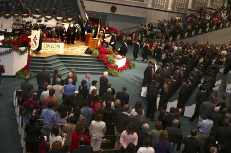 Families, friends, and graduates remain standing as the faculty take their seats during the graduation ceremony held at West Jackson Baptist Church. - Photo by Stephanie Schroeder