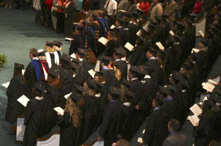 Faculty and graduates sing the alma mater during the graduation ceremony held at West Jackson Baptist Church. - Photo by Stephanie Schroeder
