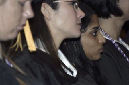 Michelle Edacheril and other graduates listen intently as President Dockery makes his closing remarks during the graduation ceremony. - Photo by Stephanie Schroeder