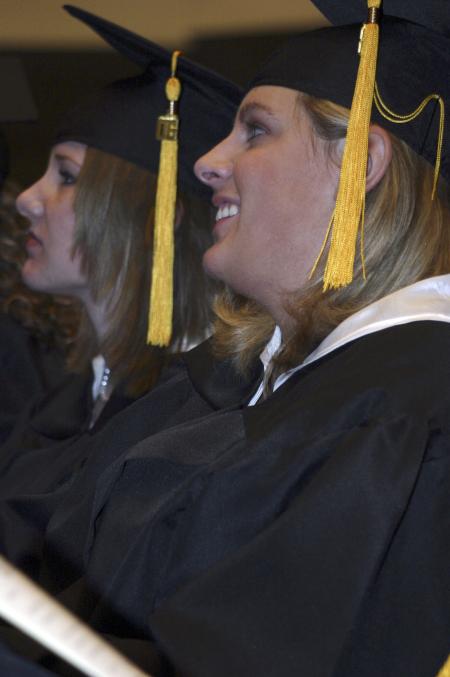 Jennifer Ruggirello and April Welch listen as President Dockery makes his closing remarks during the fall graduation ceremony. - Photo by Stephanie Schroeder