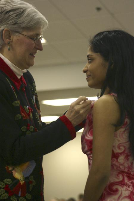 Michelle Edacheril receives her pin from Tharon Kirk during the nursing pinnning ceremony held before graduation. - Photo by Stephanie Schroeder