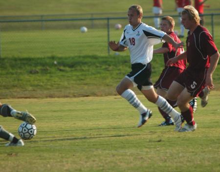 Christopher Prentice tries to outrun his opponents down the field. - Photo by Steven Aldridge