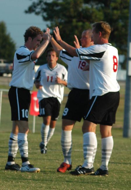 Benny Crozier (10), Gareth Munro (19), and Mark Forrest (9) celebrate after a Union goal. - Photo by Steven Aldridge