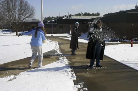 Alyssa Bantz and Samuel Parrish attack Nikki Frist with snow balls outside the Student Union Building and the Penick Academic Complex. - Photo by Stephanie Schroeder