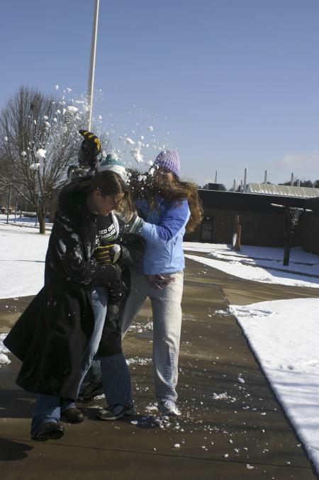 Nikki Frist is attacked by Samuel Parrish and Alyssa Bantz with snow balls outside the Student Union Building and the Penick Academic Complex. - Photo by Stephanie Schroeder