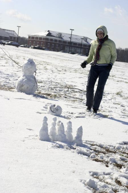 Racheal Pressnell ventured to the intramural field  to imitate the Calvin and Hobbs winter cartoon strip series, one of which includes miniature snowmen as bowling pins and the bigger snowman's head as the bowling ball. - Photo by Stephanie Schroeder