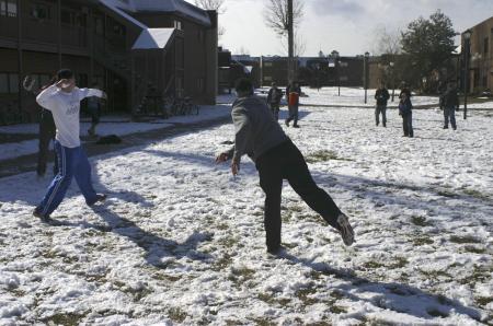 The men of McAfee formed alliances to stage a snow ball fight in the McAfee courtyard during the snow day on  campus. - Photo by Stephanie Schroeder