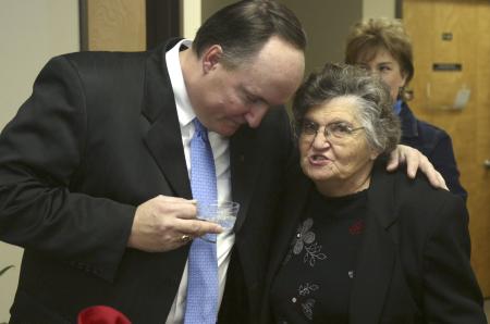 Jerry Tidwell gives a hug to Garvalene Byrd during a reception held after chapel outside the President's Office. - Photo by Stephanie Schroeder