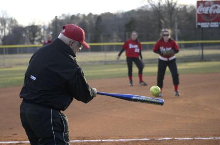 David Blackstock, Union softball coach, practices with the Lady Bulldogs in a warm-up before a game against Spring Arbor University, Mich. Blackstock was recently inducted into the Tennessee Sports Hall of Fame for 2007. - Photo by Stephanie Schroeder