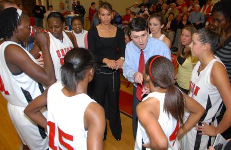 Coaches Mark Campbell and Stephanie Clark encourage the Lady Bulldogs during the semi-final game against Lambuth during the TranSouth Tournament. - Photo by Morris Abernathy