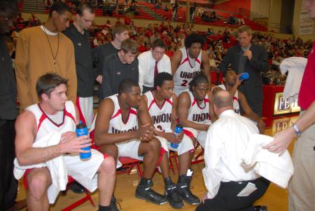 Head Coach Ralph Turner strategizes with the Bulldogs during a timeout in the semi-final game of the TranSouth Tournament against Lambuth. - Photo by Morris Abernathy