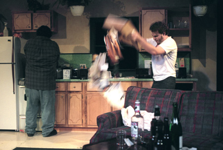 James Nolen makes toast while Jeremy Young destroys the kitchen looking for a pen during <i>True West</i>, a Sam Shepherd play directed by Graham Hillard. - Photo by Jim Veneman