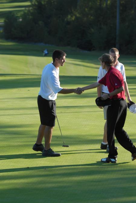 Matt Wood shakes the hand of his competitors following a round in the Union Invitational at Falcon Ridge Golf Club. - Photo by Morris Abernathy