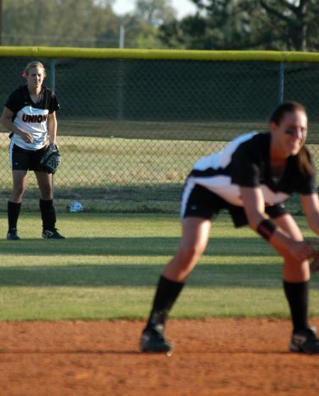 Juniors Amy Chatham (back) in centerfield and Ashley Walters (front) as shortstop get ready for play. - Photo by Steven Aldridge