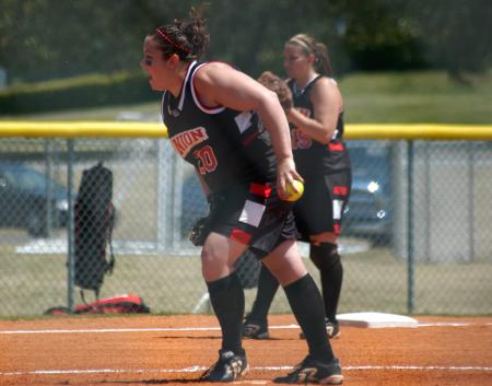 Cassie Turley goes into her wind-up as third baseman Mandy Elder get ready. - Photo by Steven Aldridge