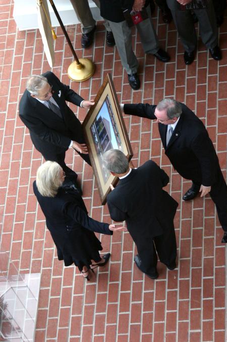 President David S. Dockery and Board of Trustees Chairman Harry Smith present a portrait of White Hall to Roy and Martha White. The Whites made the lead gift for the new science building that bears their name. - Photo by Stephanie Schroeder
