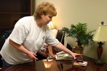 Molly Wright, assistant professor of nursing, arranges her office in preparation for the White Hall dedication. 
 - Photo by Stephanie Schroeder