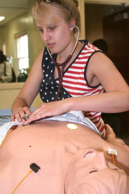 Cara-Anne  Phillips checks the breathing patterns on the <em>Lazarus</em> simulator during the White Hall dedication. - Photo by Kyle Kurlick