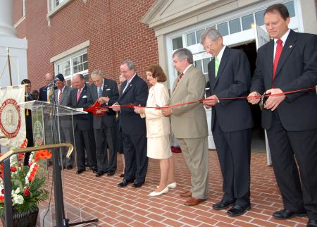 Those who had a leading role in the development of White Hall prepare for the ceremonial ribbon-cutting. From top to bottom: Jim Moss, West Tennessee Healthcare; Bill Dement, Union Board of Regents; Bob Campbell, Union Board of Trustees; Roy and Martha White, lead donors; President David S. Dockery; Elsie Smith, associate professor of biology; Frank Wagster, TLM Associates architect; Harry Smith, Chairman, Union Board of Trustees; and Gary Carter, senior VP for business services. - Photo by Morris Abernathy
