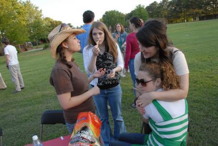 Bekah McElhannon, Cara Yates, Keely Hart and Jessica Ramsey enjoy some final moments together as students at the Happy Trails event. - Photo by Morris Abernathy
