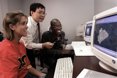 Don Van, department chair & associate professor of engineering, works with students in the engineering computer lab. - Photo by Jim Veneman