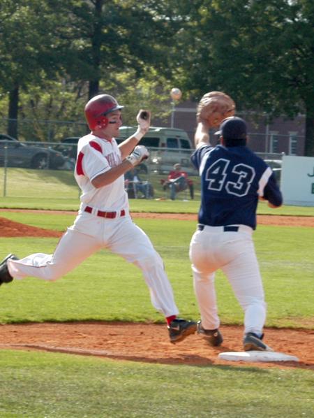 Jason Cooper tries to beat out a ground ball as the throw comes into first base. - Photo by Steven Aldridge