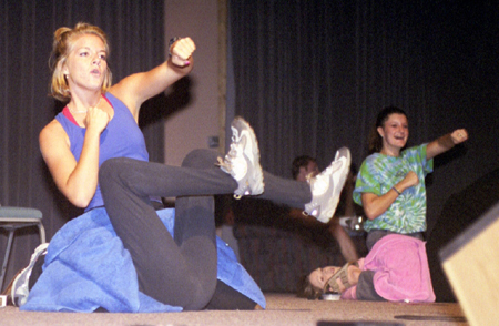 Freshmen Adrienne Briles and Charli Cox perform a unique workout sequence at the Variety Show during New Student Orientation. - Photo by Mykle Harchfield Johnson