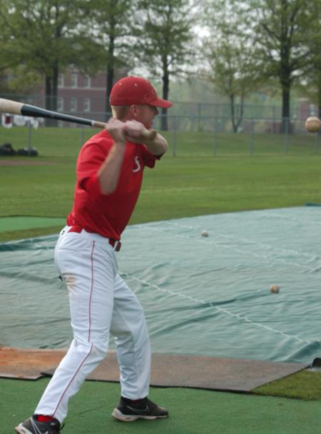 Graduate assistant coach David Canary his fungos during pre-game batting practice. - Photo by Steven Aldridge