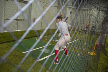 Members of the baseball team test out Fesmire Field House, their new training facility. - Photo by Morris Abernathy