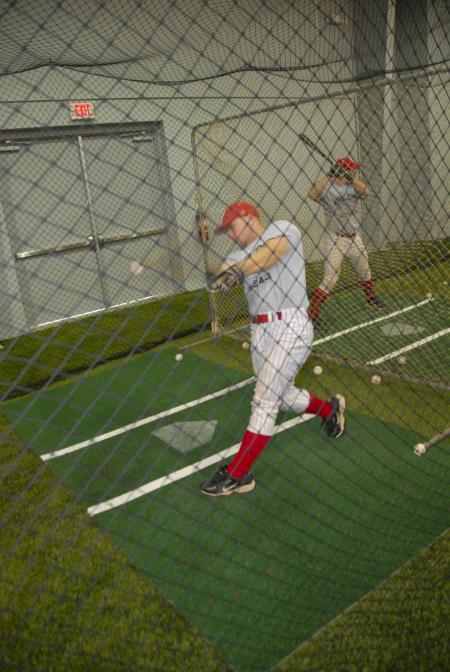Members of the baseball team test out Fesmire Field House, their new training facility. - Photo by Morris Abernathy